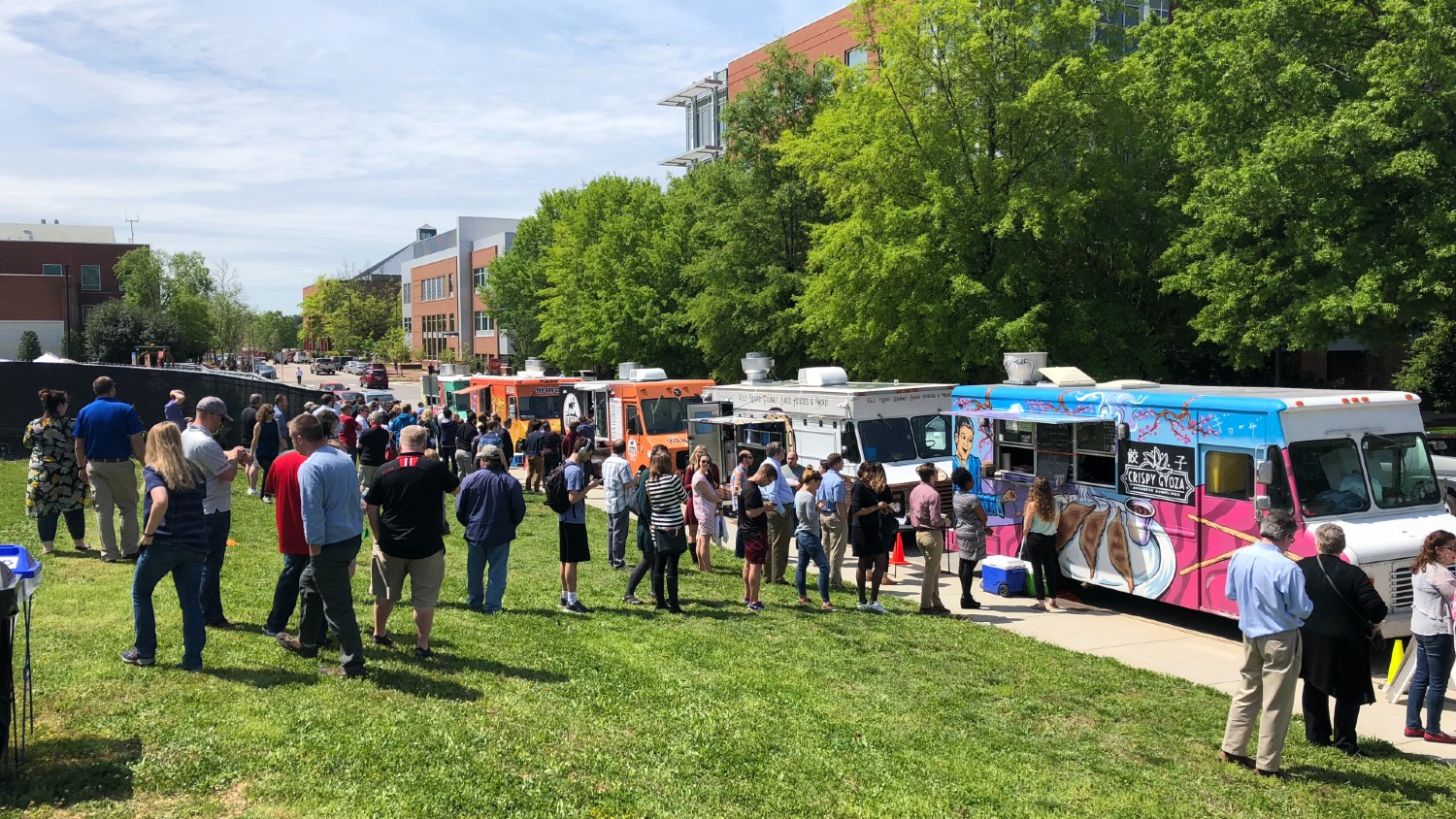 A line of people waiting for a food truck