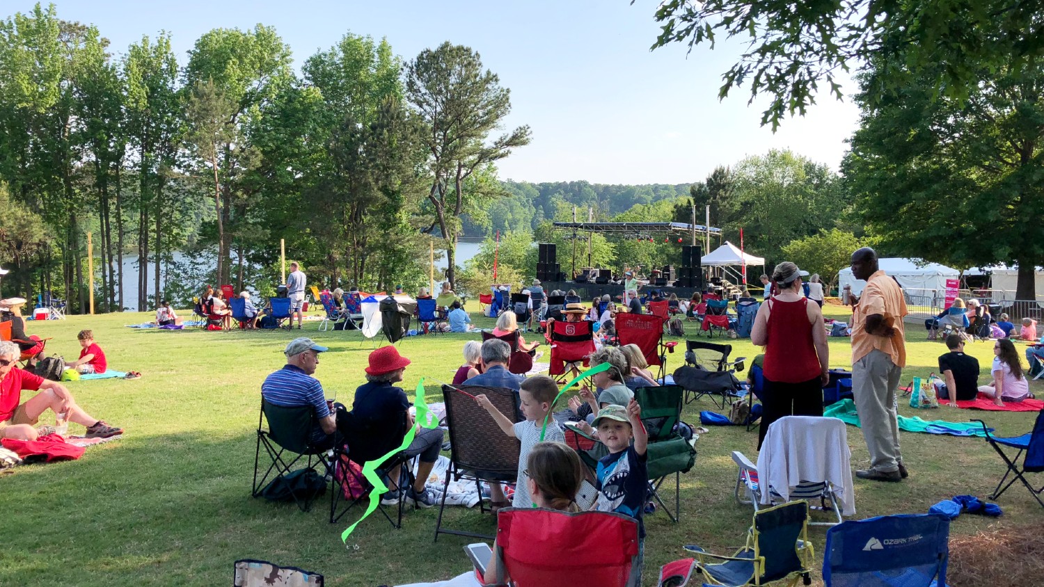 A crowd gathers on the lawn for a concert